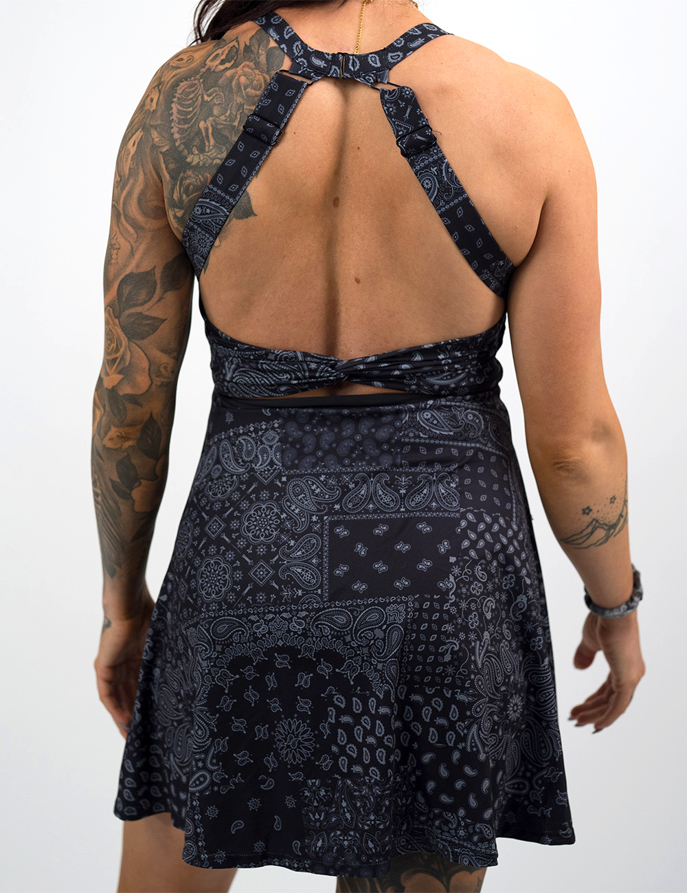 back of the black active dress with white accents against a white background