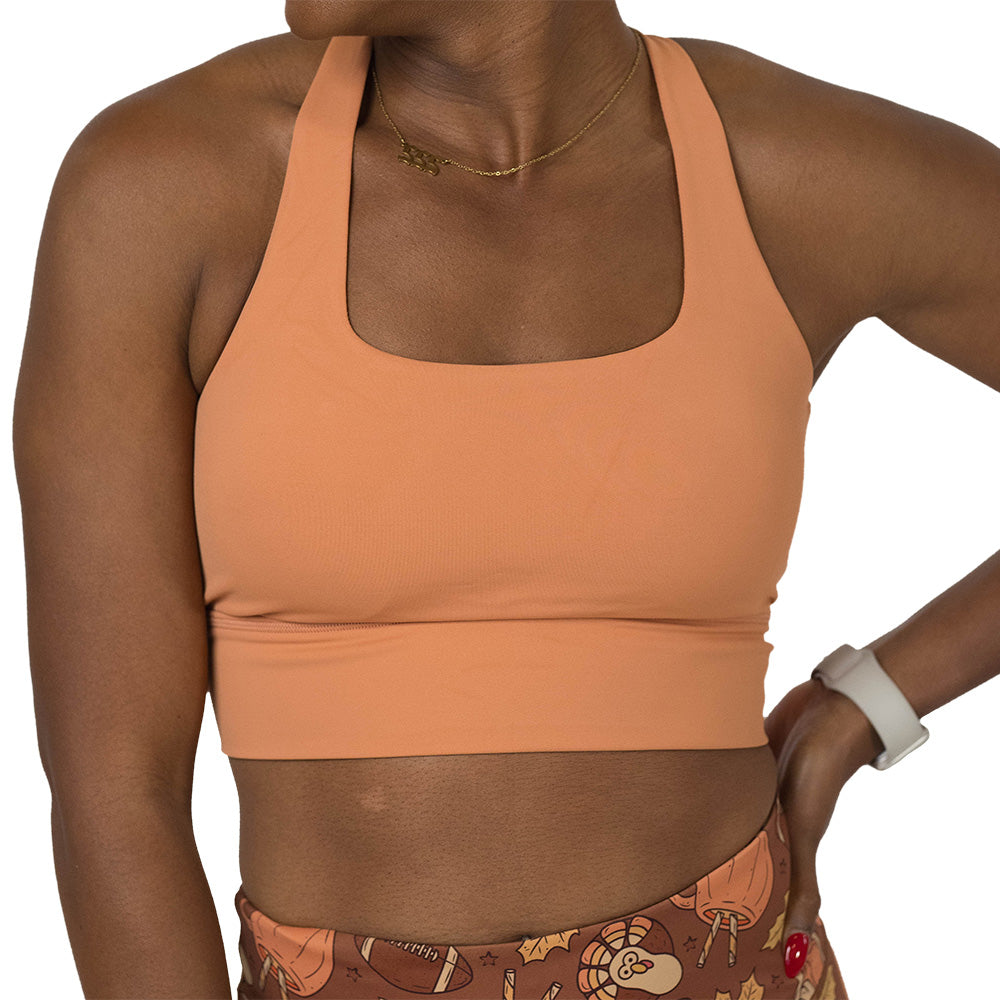 Person wearing a peach-colored sports bra