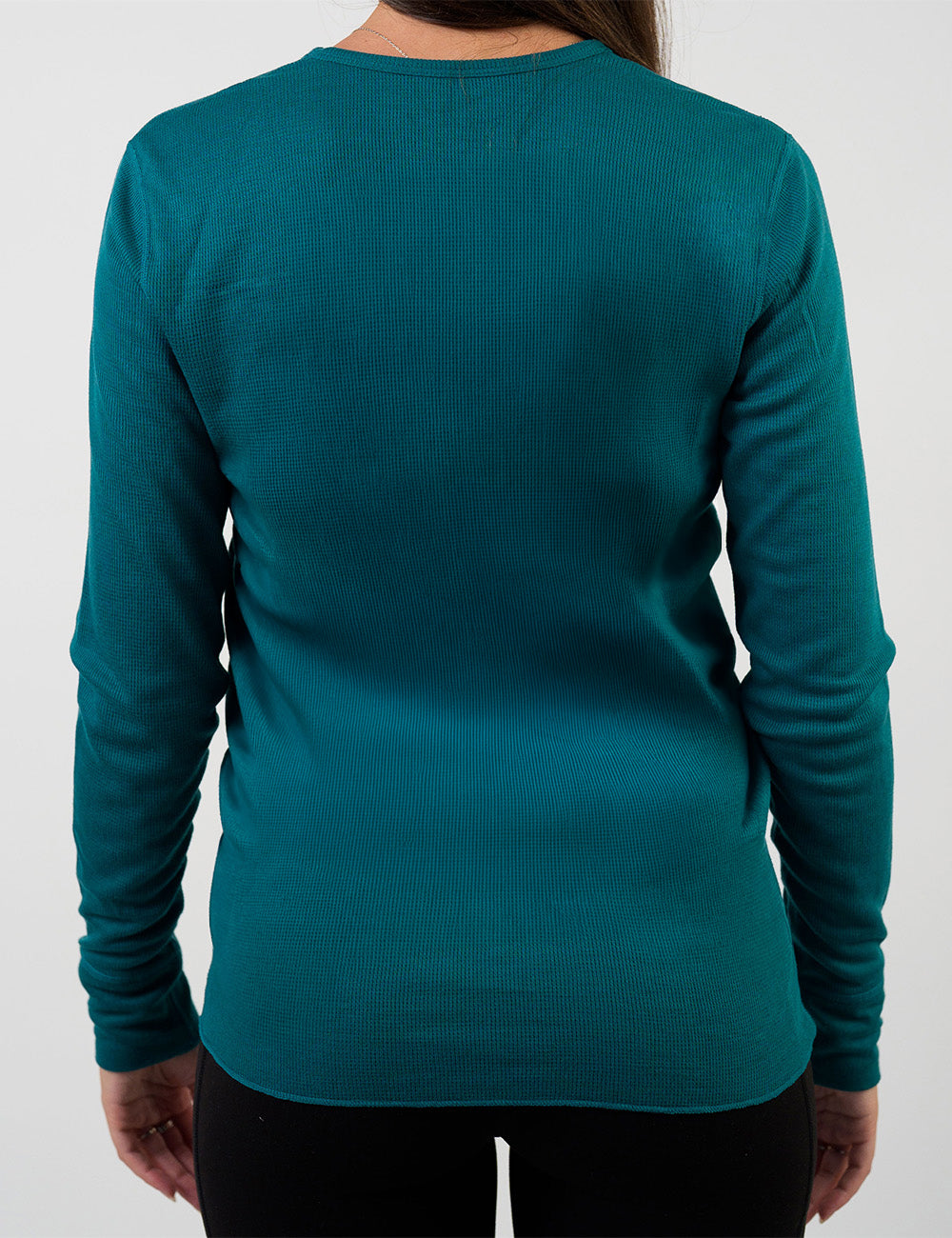 back of the dark teal thermal against a white background