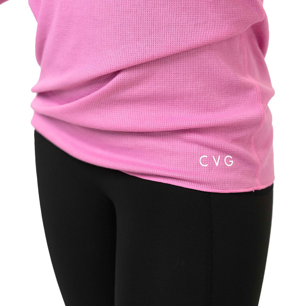 close up of the CVG logo on a pink long-sleeve