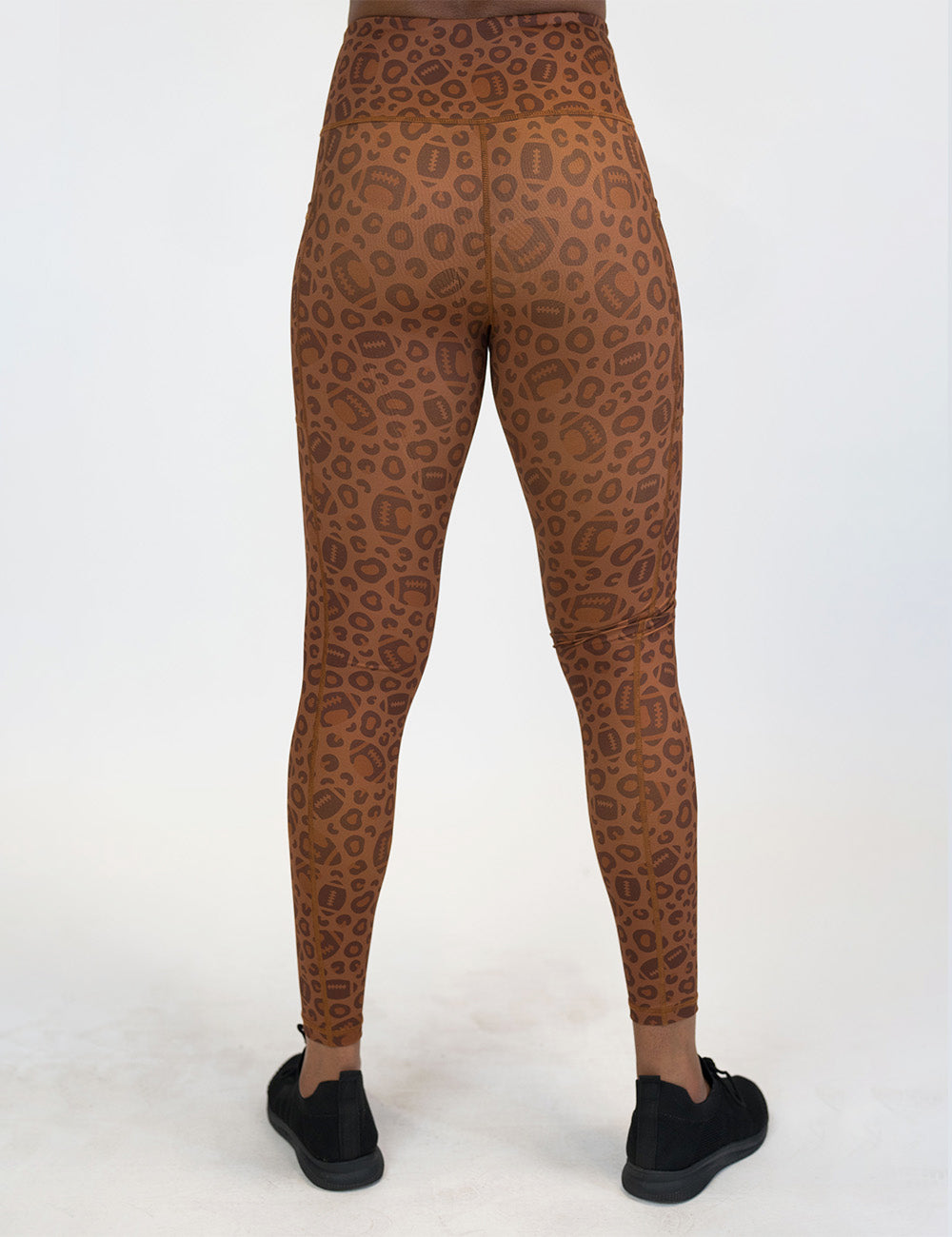 back of the football themed brown leopard print full length leggings against a white background