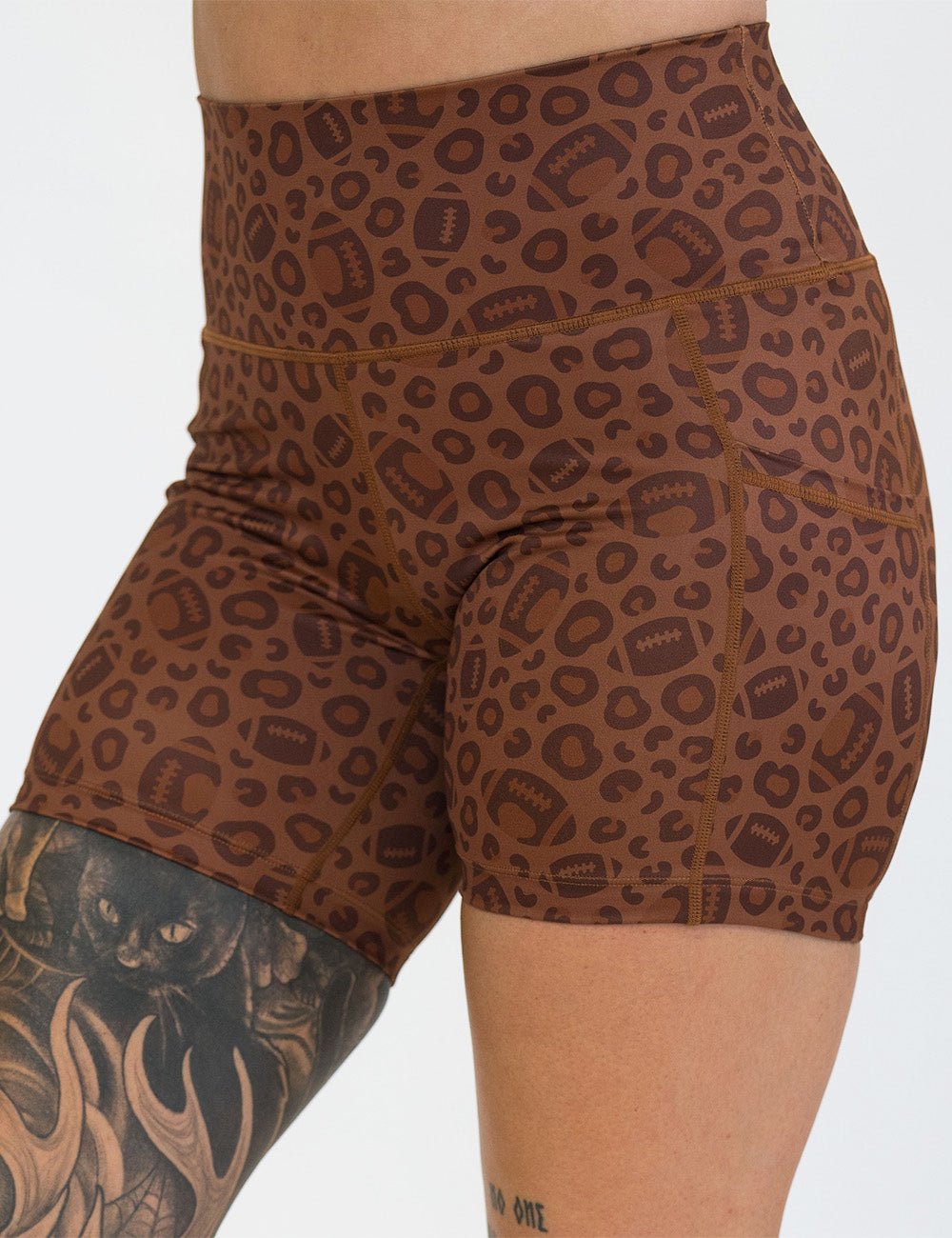 front of the football themed brown leopard print 5 inch shorts against a white background