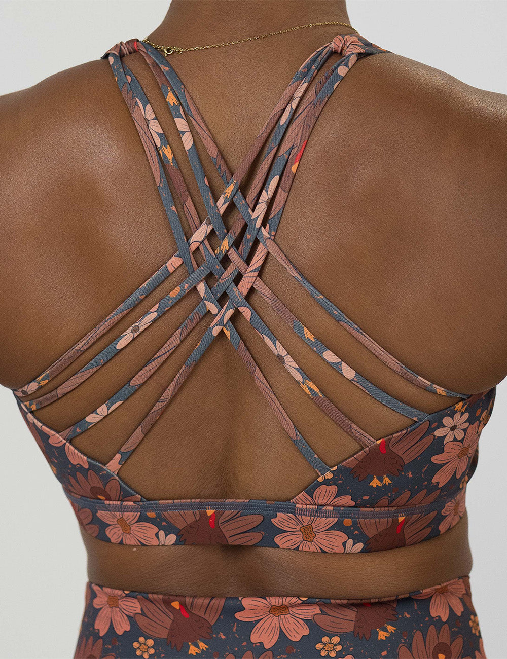 back of the turkeys over a blue background sports bra against a white background
