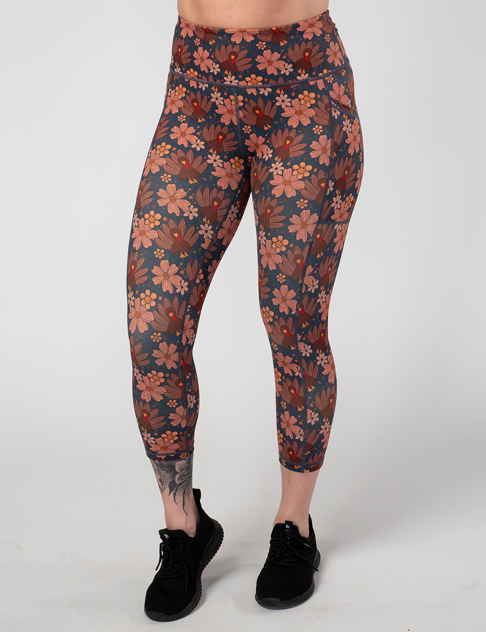 front of the turkeys over a blue background capri leggings against a white background