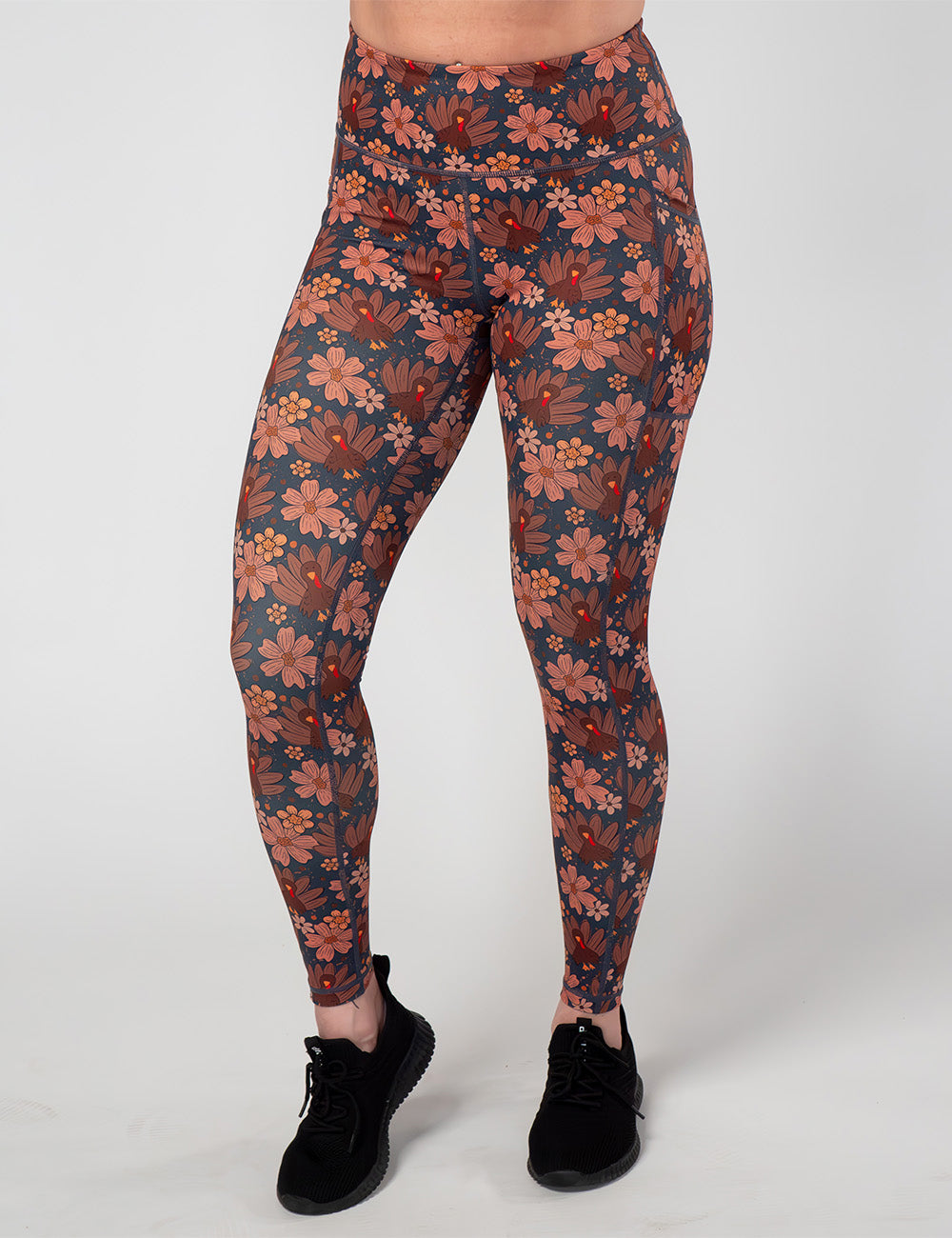 front of the turkeys over a blue background full length leggings against a white background