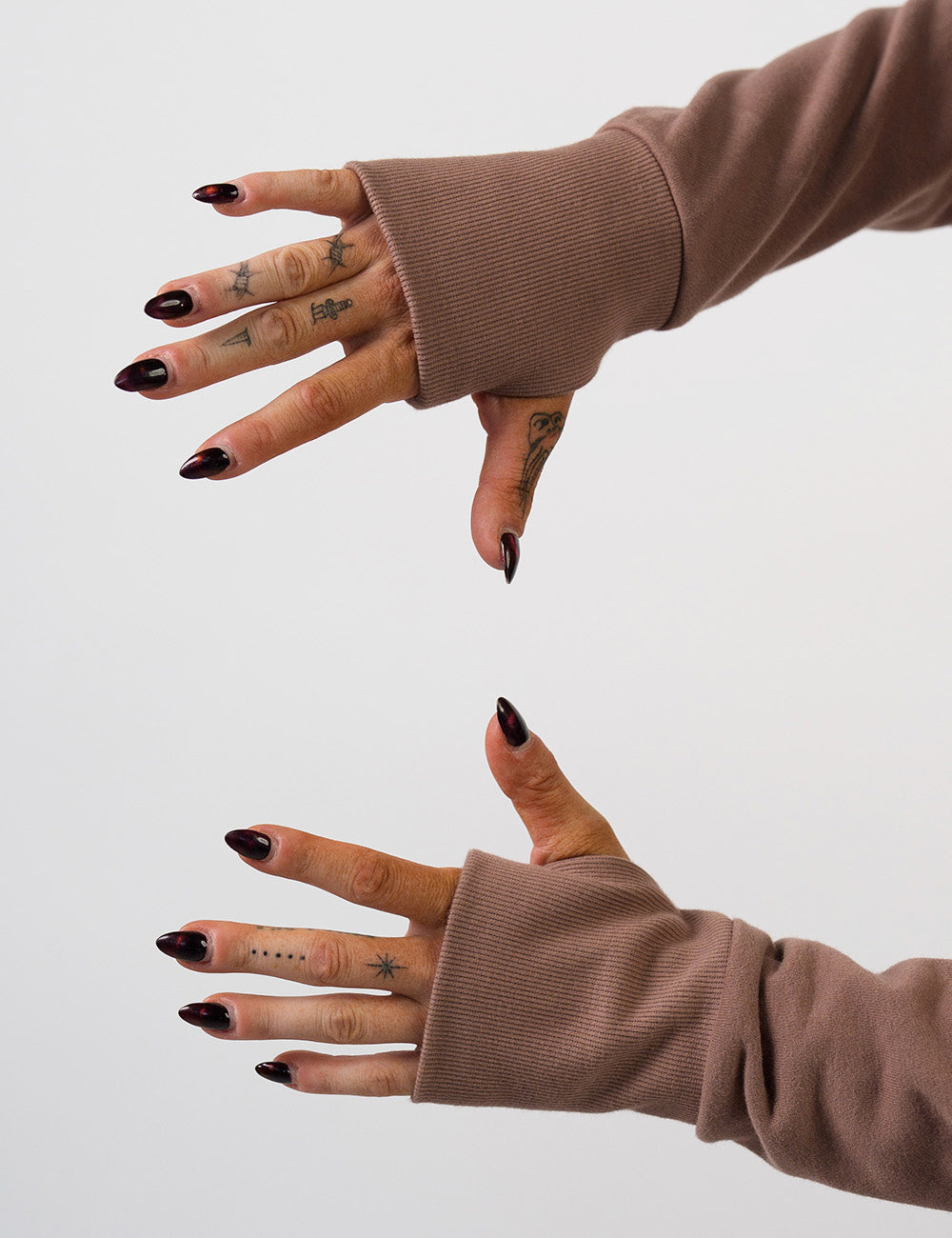 close up of the brown hoodie's thumbholes on the sleeves