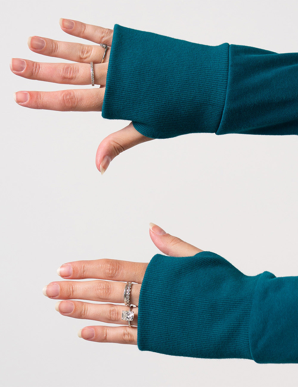 close up of the thumbholes in the sleeves of the dark blue hoodie