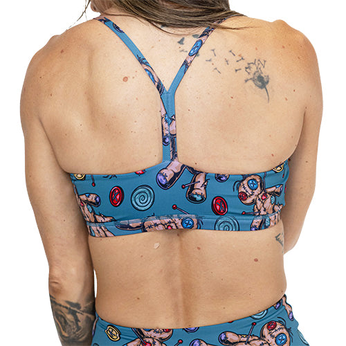 back of blue voodoo doll print sports bra