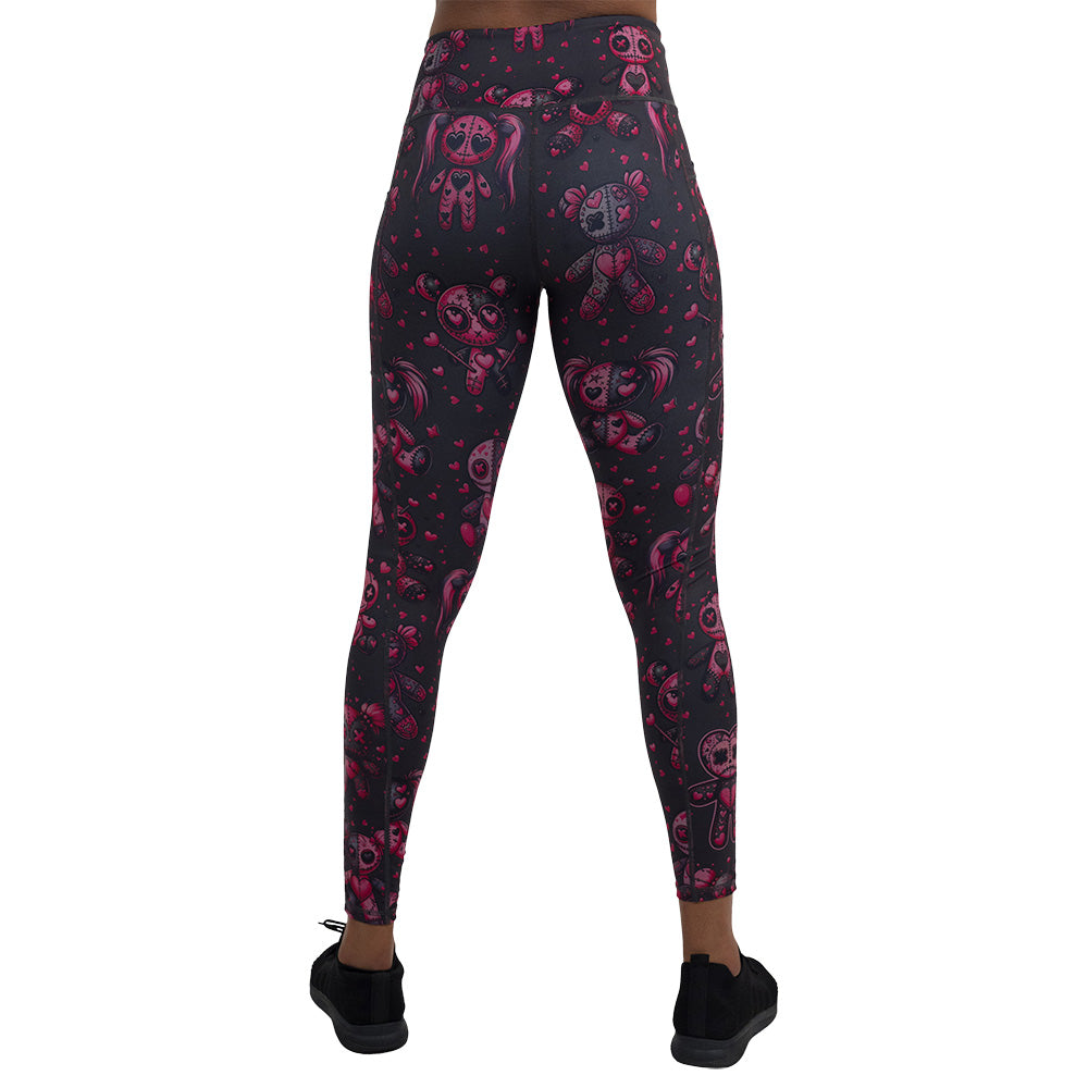 back of the pink voodoo doll with pink hearts pattern full length leggings against a white background