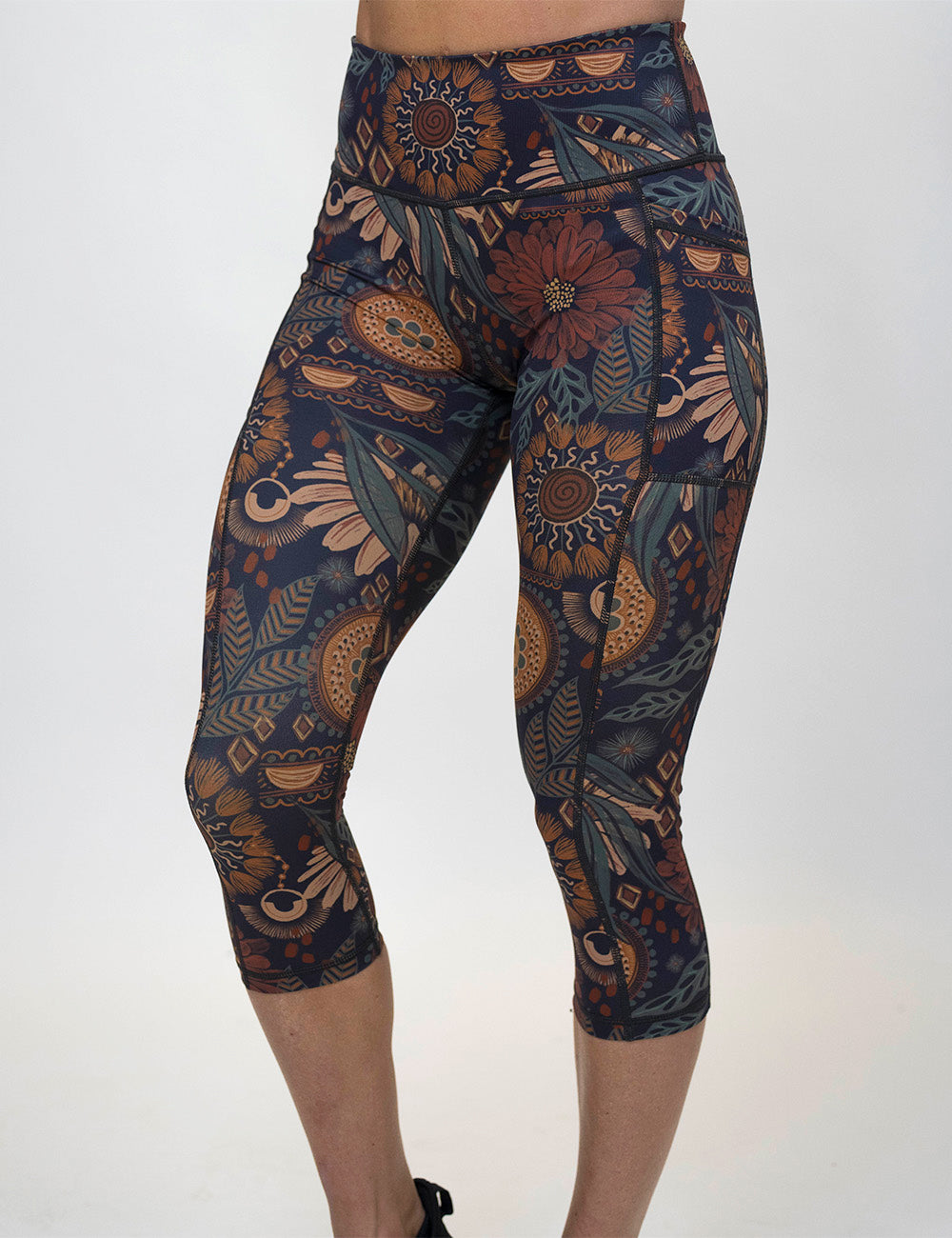 front of the paisley flowers capri leggings against a white background