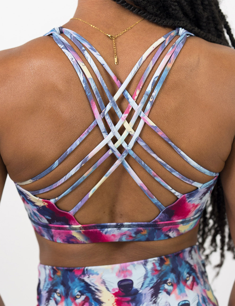 back of the watercolor style red, white, blue, and yellow wolves butterfly back bra against a white background