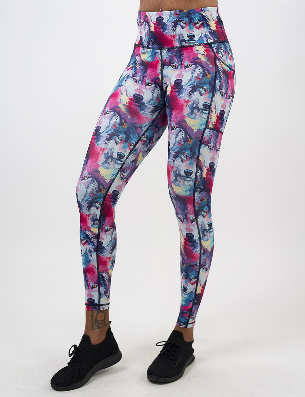front of the full length red, blue, white, and yellow water color style wolves full length leggings against a white background