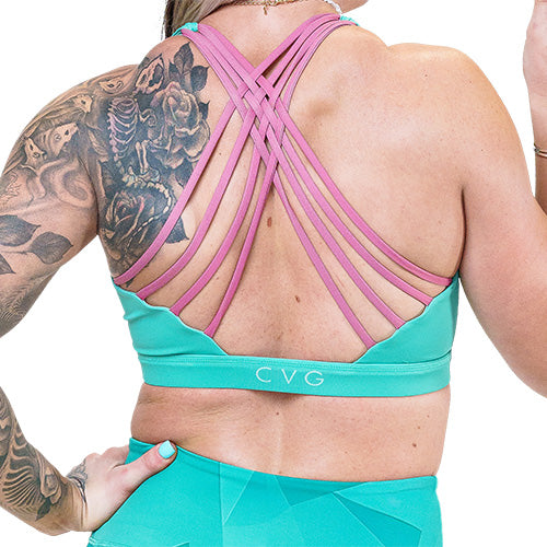 back of teal sports bra with pink straps