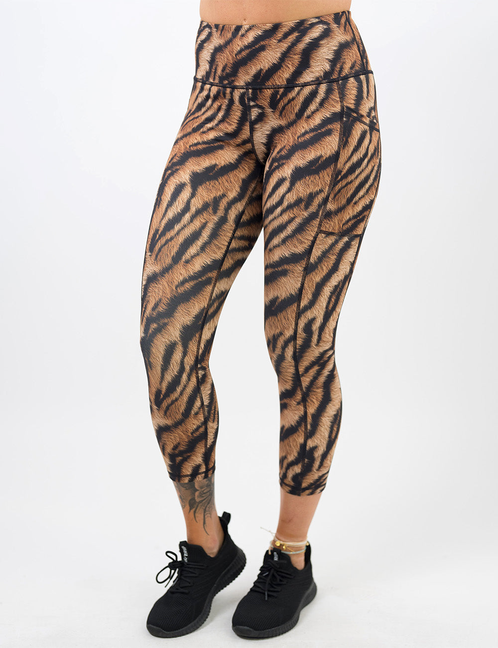 front of the full length tiger print capri leggings against a white background