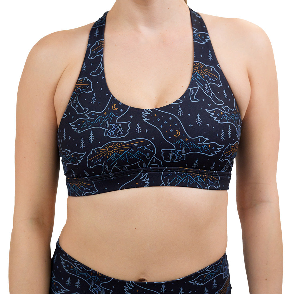 front of the bird and bear outlines against a dark background butterfly back bra against a white background