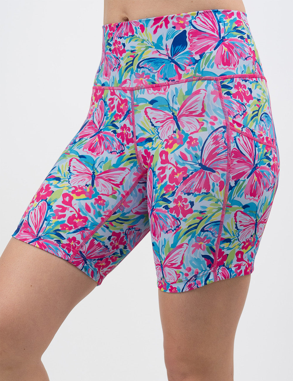 front of the 7 inch pink butterflies against a colorful floral background shorts