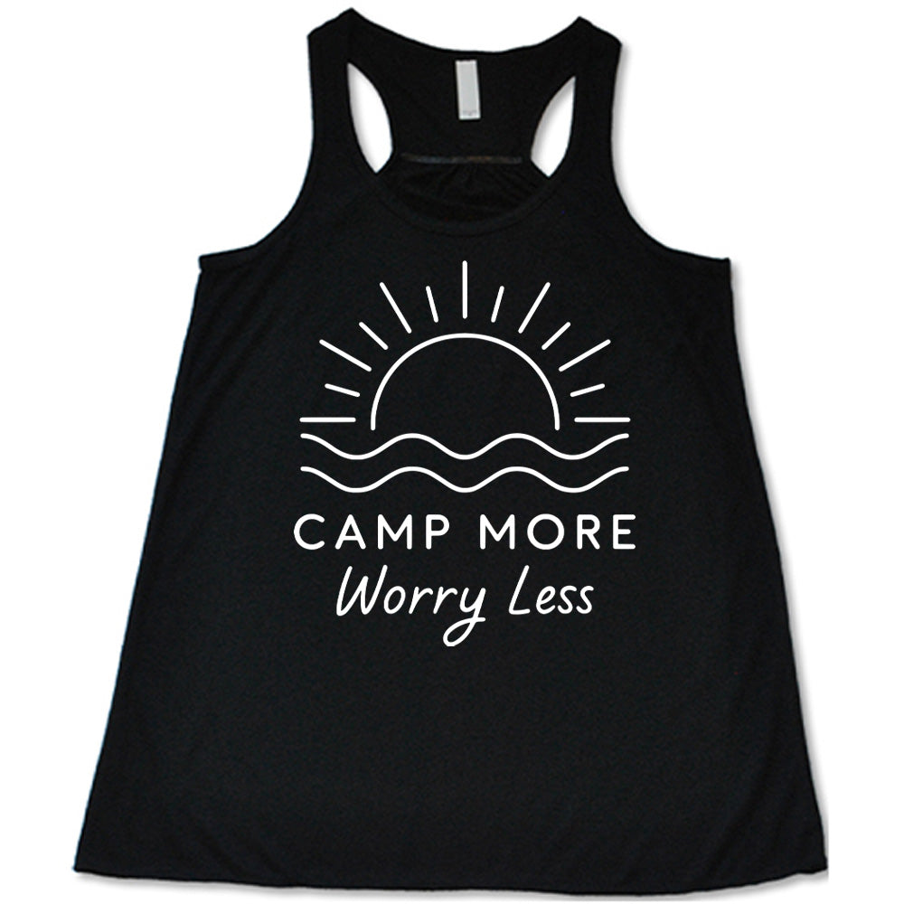 black flowy tank with the words "camp more worry less" on it, under the line art graphic of a large sun over water