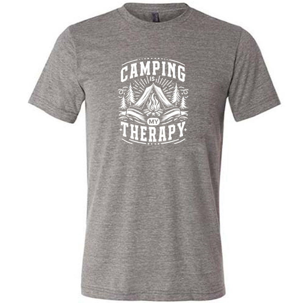Grey colored shirt with a campfire graphic on it that says "Camping Is My Therapy" 