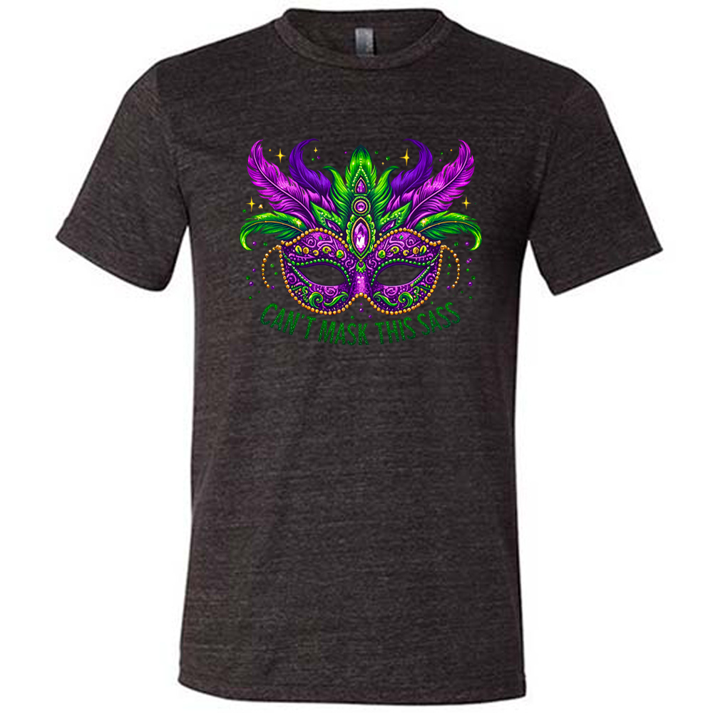 black unisex tee with the graphic of a fancy, feathered and bejeweled, and colorful mardi gras mask, and words underneath saying "can't mask this sass"
