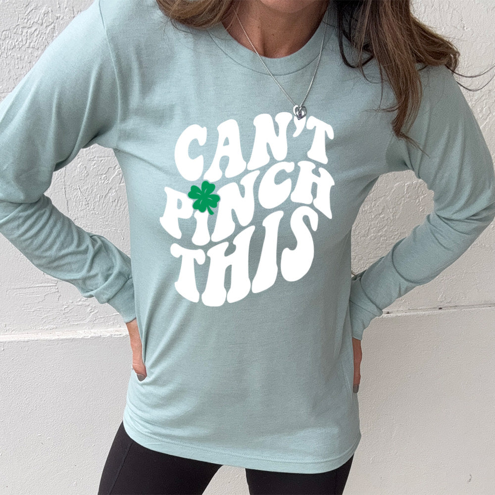 heather dusty blue long sleeve with the words "can't pinch this" with a clover above the "i" of "pinch"
