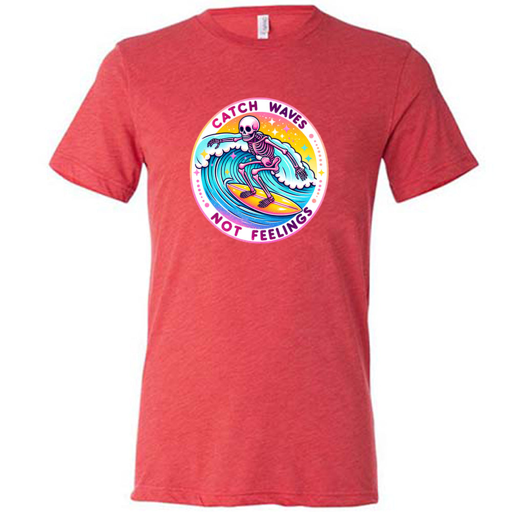 Red colored shirt with a skeleton surfing graphic on it that says "Catch Waves Not Feelings" 