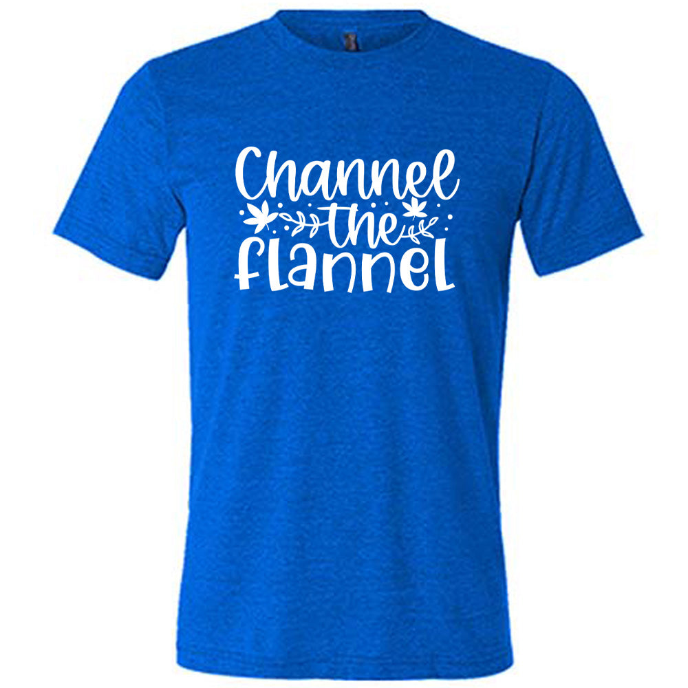 Blue colored shirt with fall leaf graphic on it that says "Channel The Flannel"