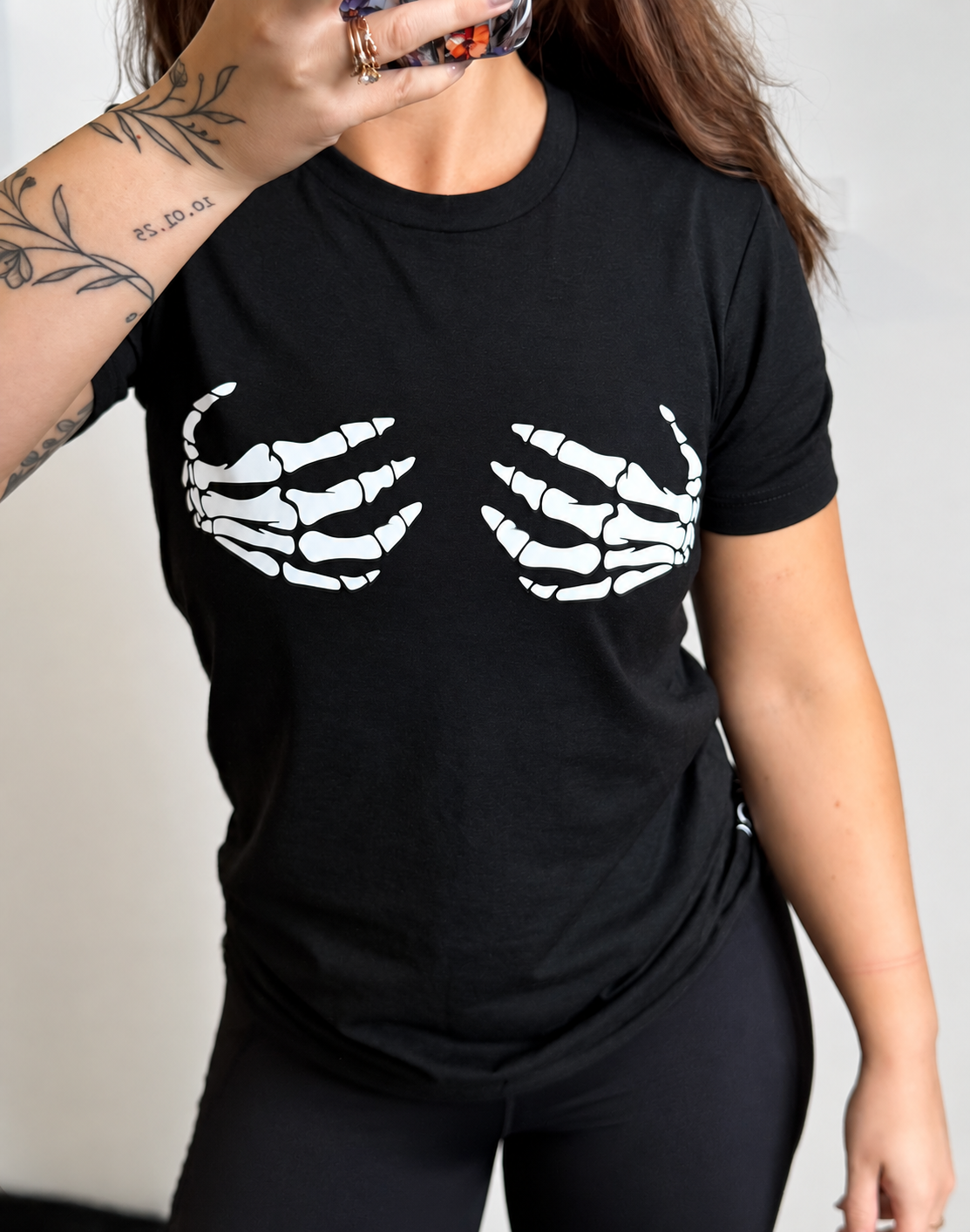 white skeleton hands on black shirt