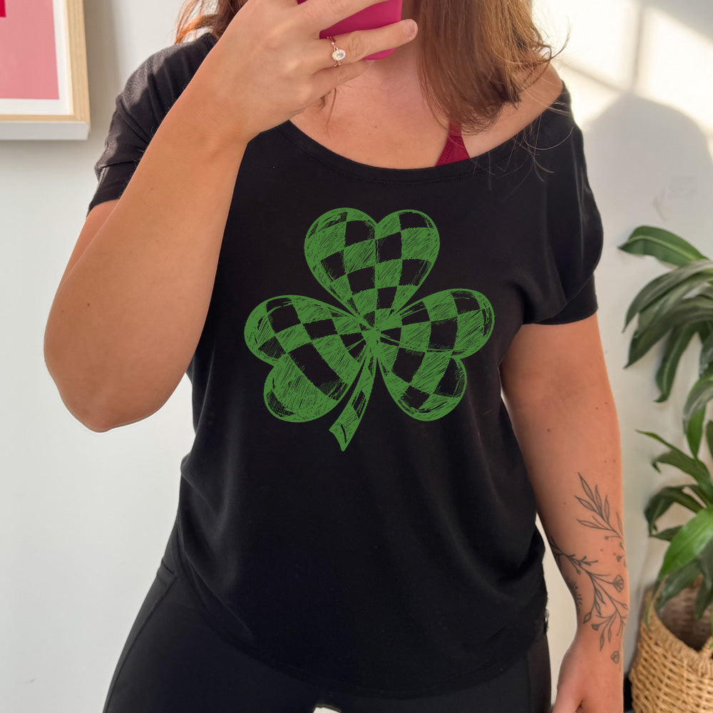black slouchy tee with the large graphic of a shamrock that is checkered on the inside