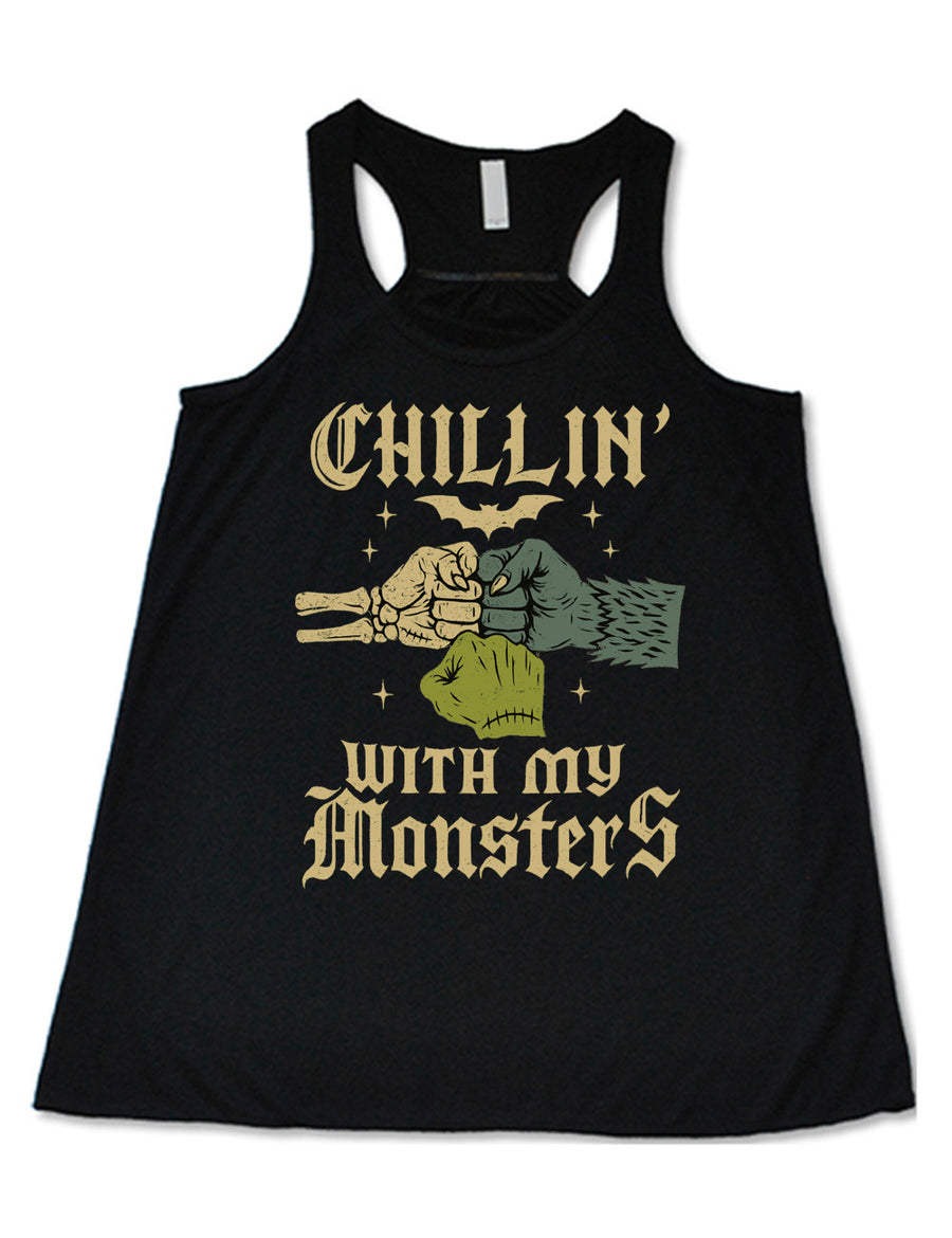 black flowy racerback tank with the words "chillin' with my monsters" around the graphic of a skeleton's hand, a werewolf's hand, and a zombie's hand, doing a fist pump, with a bat above, and few stars around 