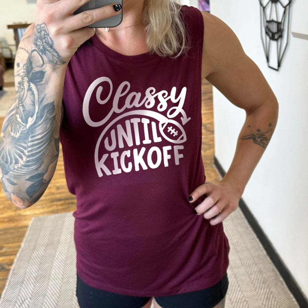 Model wearing maroon colored muscle tank with football graphic on it that says "Classy Until Kickoff"