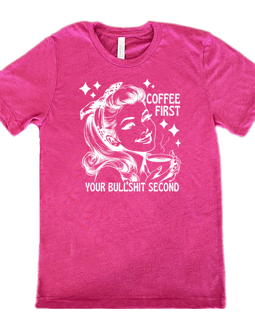 berry unisex tee with the graphic of a woman happily holding a mug of steaming coffee, with the words "coffee first" (next to her face) and "your bullshit second" underneath, and a few stars around her