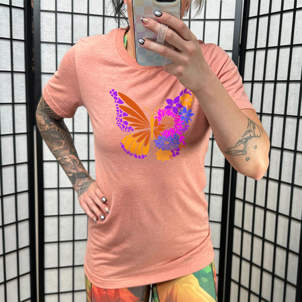 Sunset colored shirt with a floral butterfly graphic on it