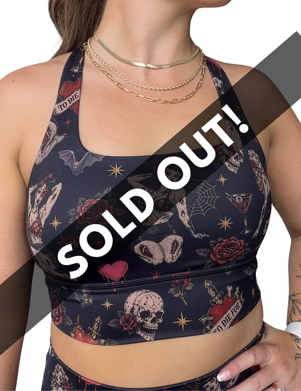 front of the zombie girls with pin up hair and traditional tattoo designs bra against a white background, sold out