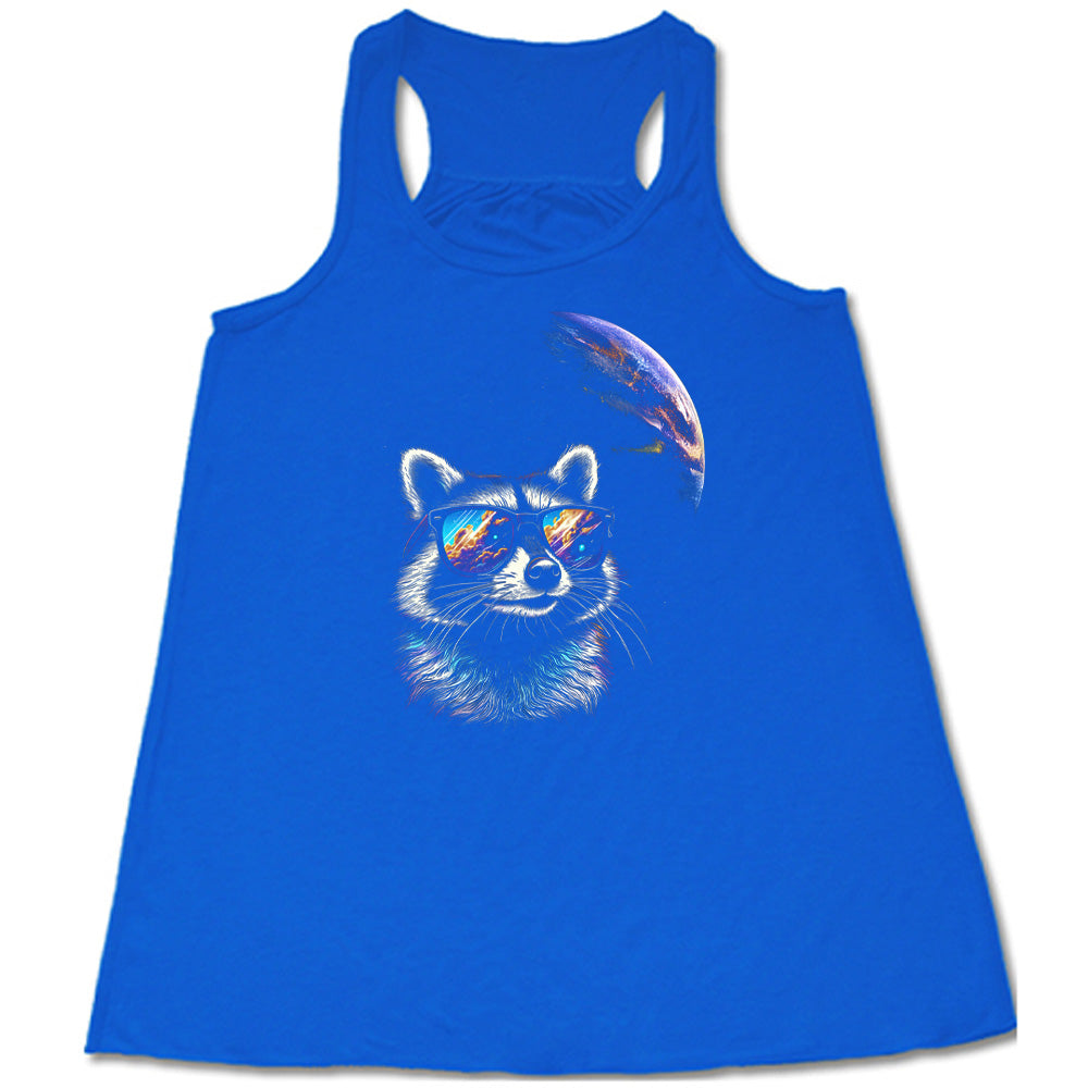 Blue colored flowy tank with a raccoon looking into space graphic on it