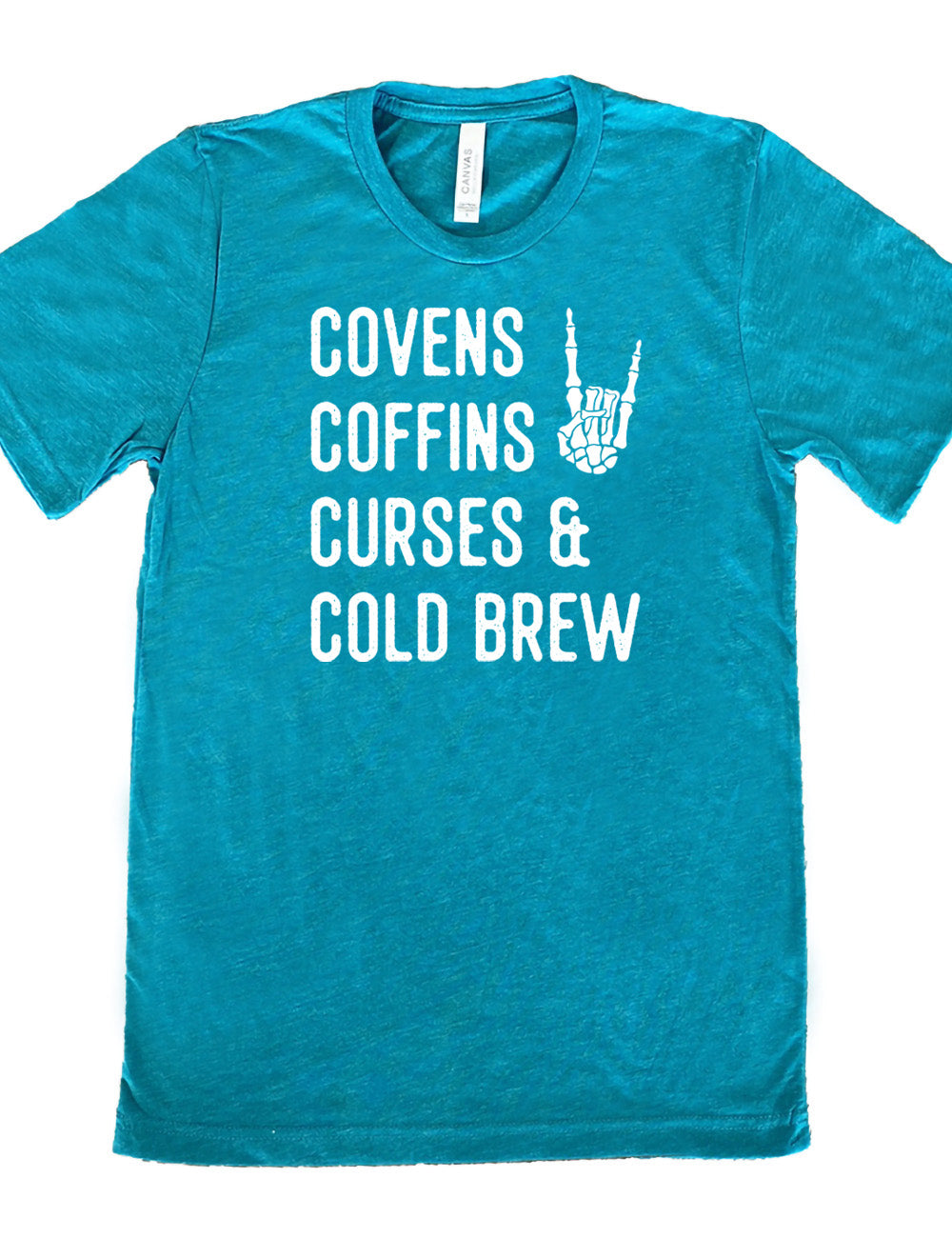 teal unisex tee with the words listed "covens coffins curses & cold brew" and the graphic of a skeletal rocker hand