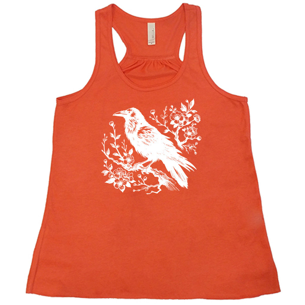 Coral colored flowy tank with crow on flowery branch graphic on it