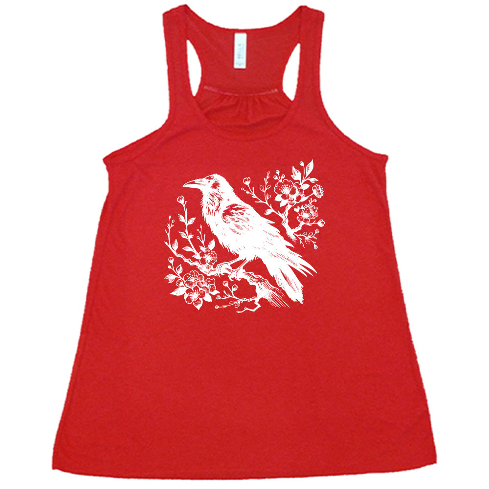 Red colored flowy tank with crow on flowery branch graphic on it