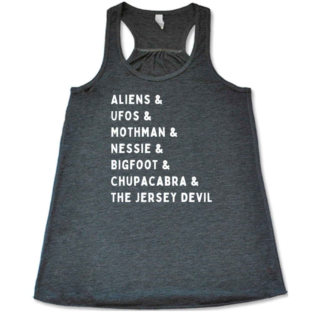Grey colored flowy tank with graphic on it that says "ALIENS & UFOS & MOTHMAN & NESSIE & BIGFOOT & CHUPACABRA & THE JERSEY DEVIL"