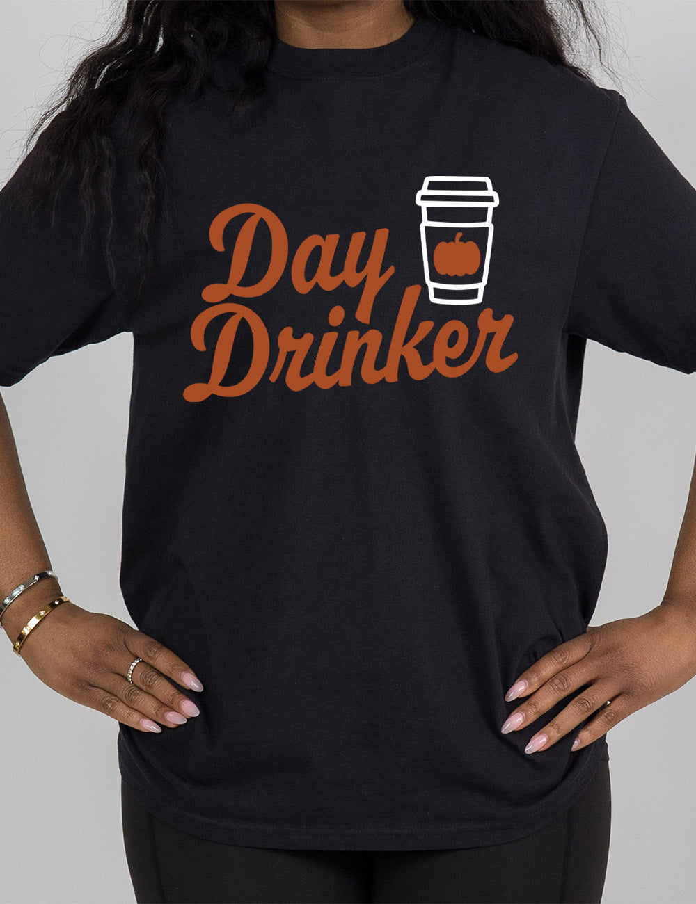 black modern tee with the words "day drinker" on it, with the graphic of a takeaway coffee cup with a pumpkin on the cup's sleeve
