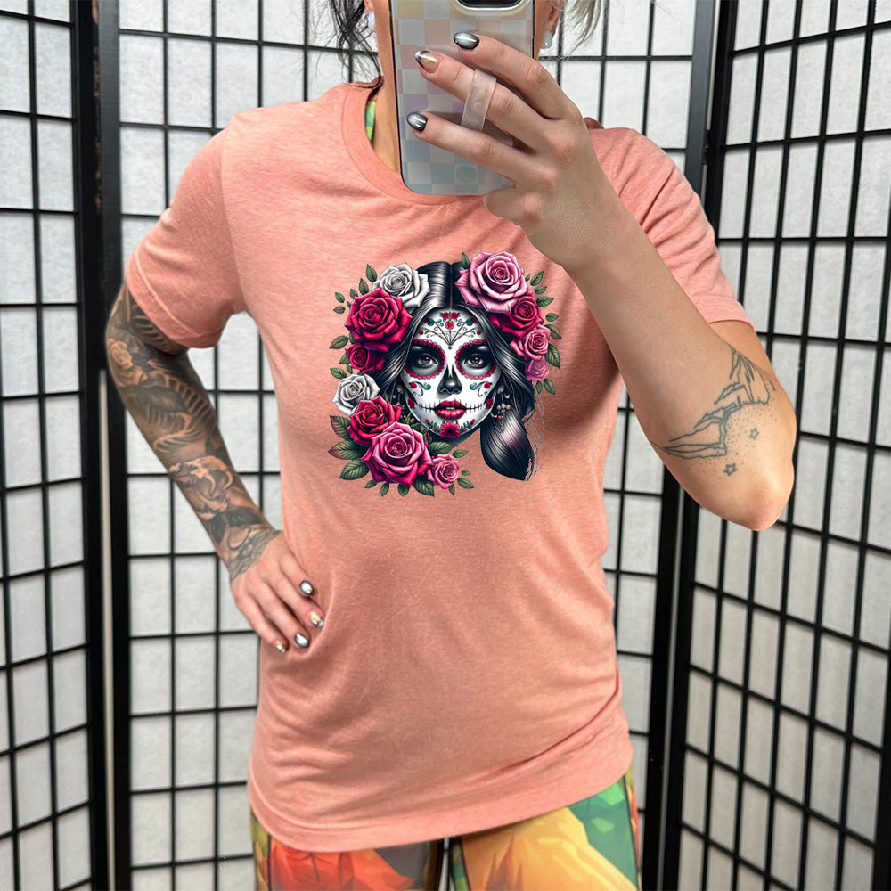 coral shirt with a Day Of The Dead graphic on it
