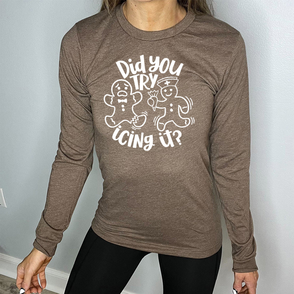 heather brown long sleeve with the words "did you try icing it?" in white lettering, with the image of an injured gingerbread person and a doctor gingerbread person running towards them with icing