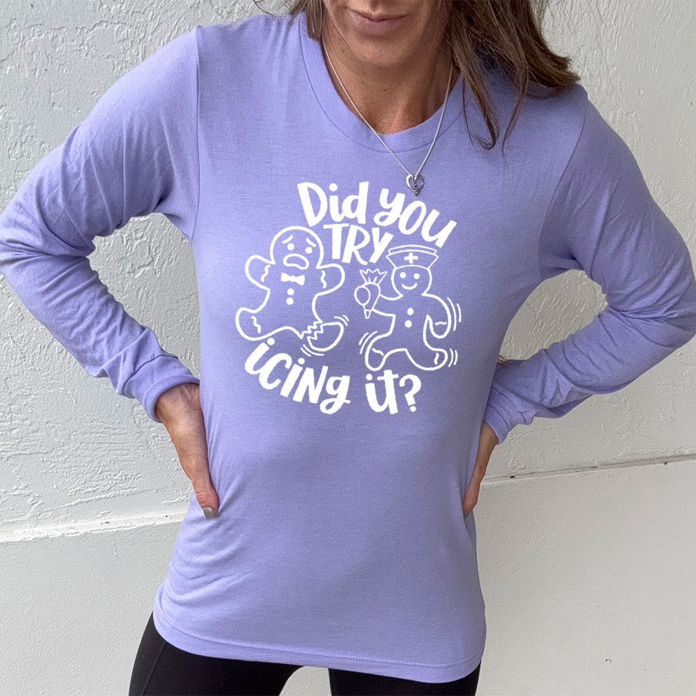 heather dark lavender long sleeve with the words "did you try icing it?" in white lettering, with the image of an injured gingerbread person and a doctor gingerbread person running towards them with icing