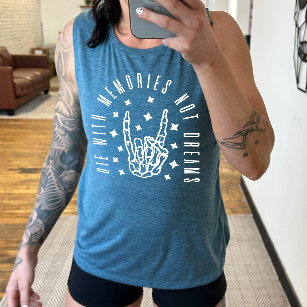 deep teal muscle tank with the graphic of a rocker skeleton hand, surrounded by little stars as well as an archway of text saying "die with memories not dreams" 