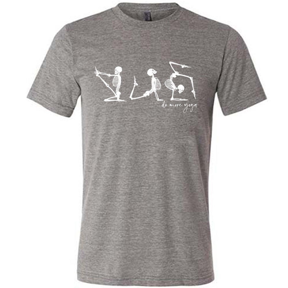 grey unisex tee with three skeleton graphics doing yoga, with the small words underneath saying "do more yoga"