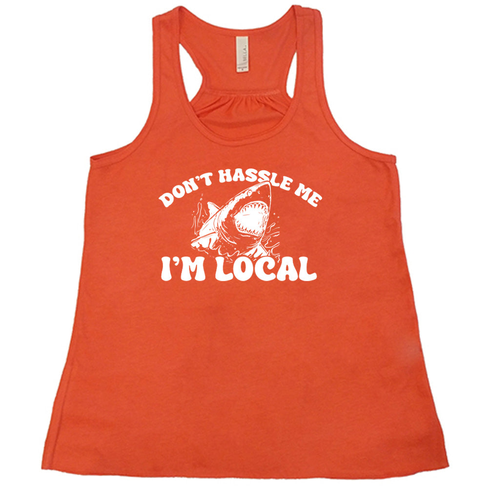 Coral colored flowy tank with a shark graphic on it that says "Don't Hassle Me I'm Local" 