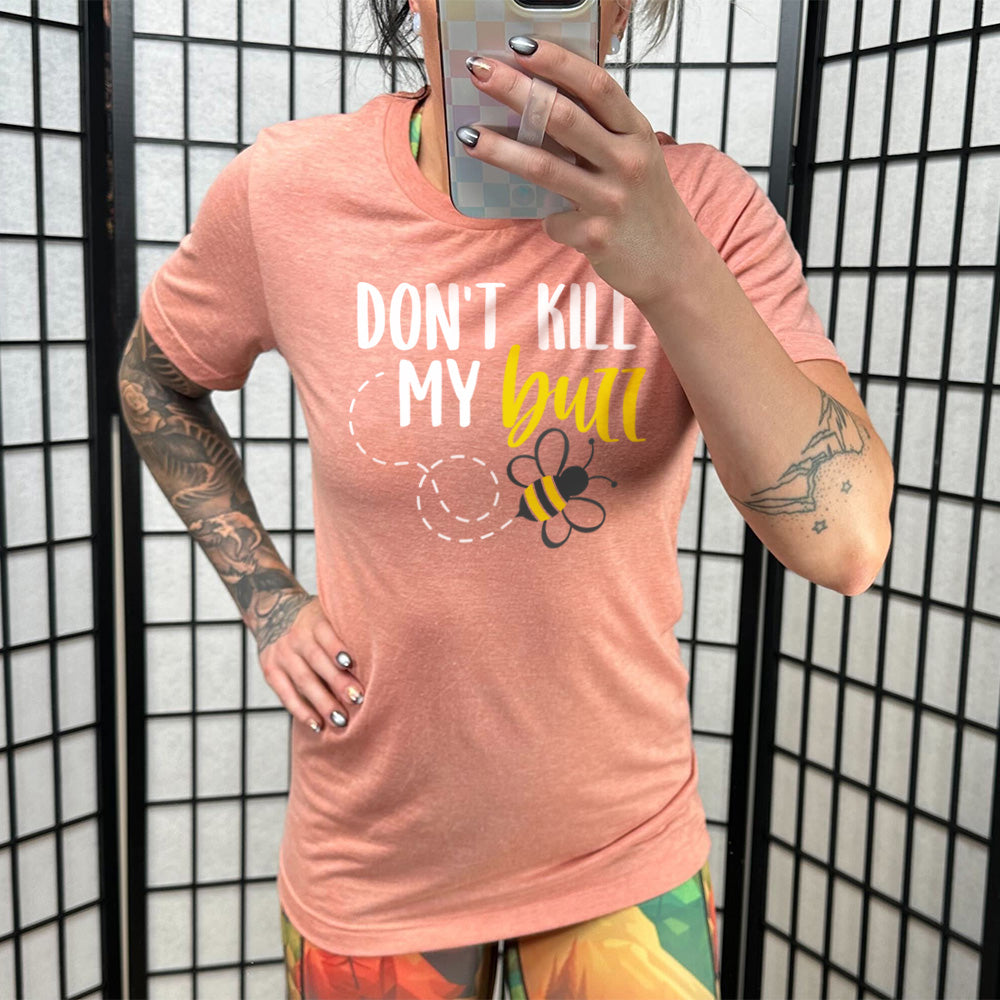 sunset unisex tee with the words "don't kill my buzz" on it, with a dashed trail leading to a bee graphic under the words