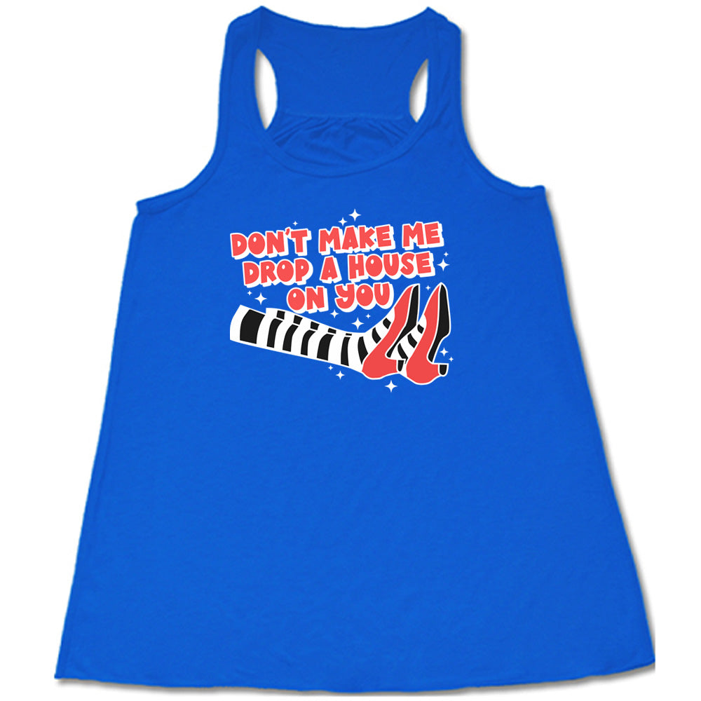 blue shirt with the text "Don't Make Me Drop A House On You" on it