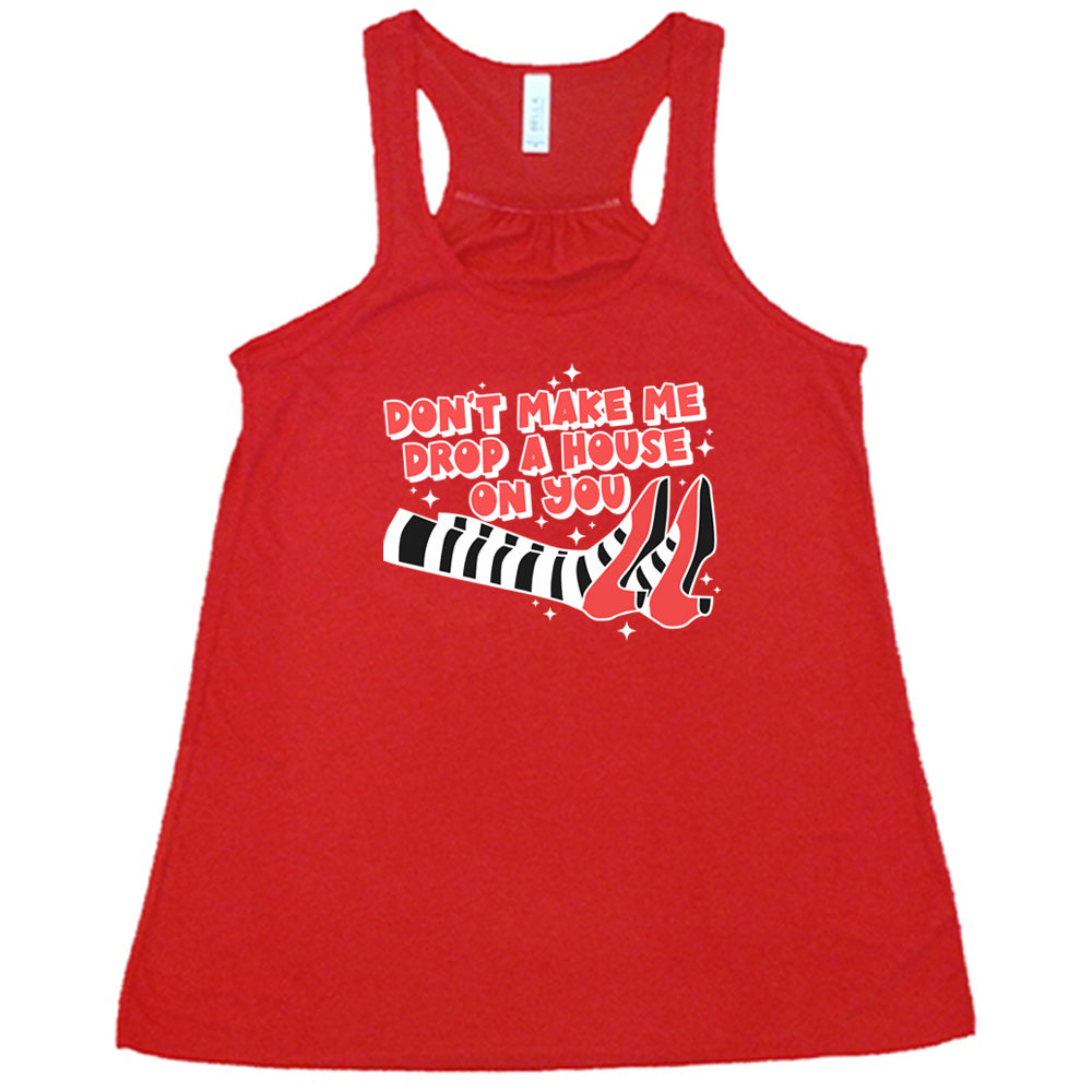 red shirt with the text "Don't Make Me Drop A House On You" on it