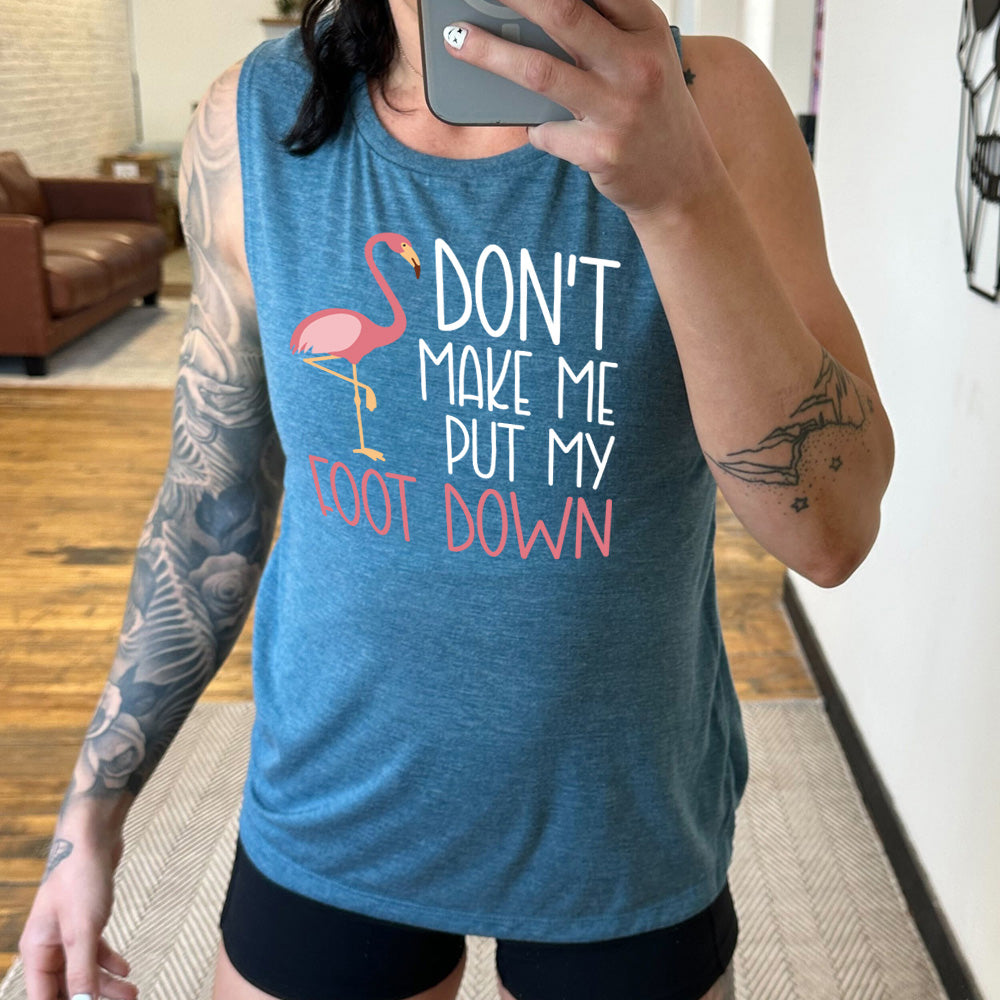 deep teal muscle tank with the words "don't make me put my foot down" on it, with the graphic of a flamingo next to the words, with its foot raised