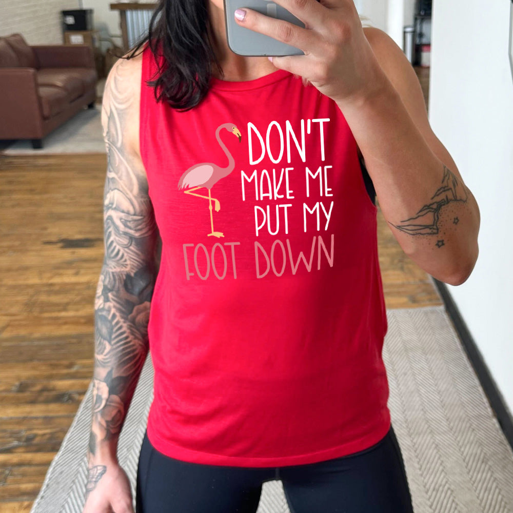 red muscle tank with the words "don't make me put my foot down" on it, with the graphic of a flamingo next to the words, with its foot raised